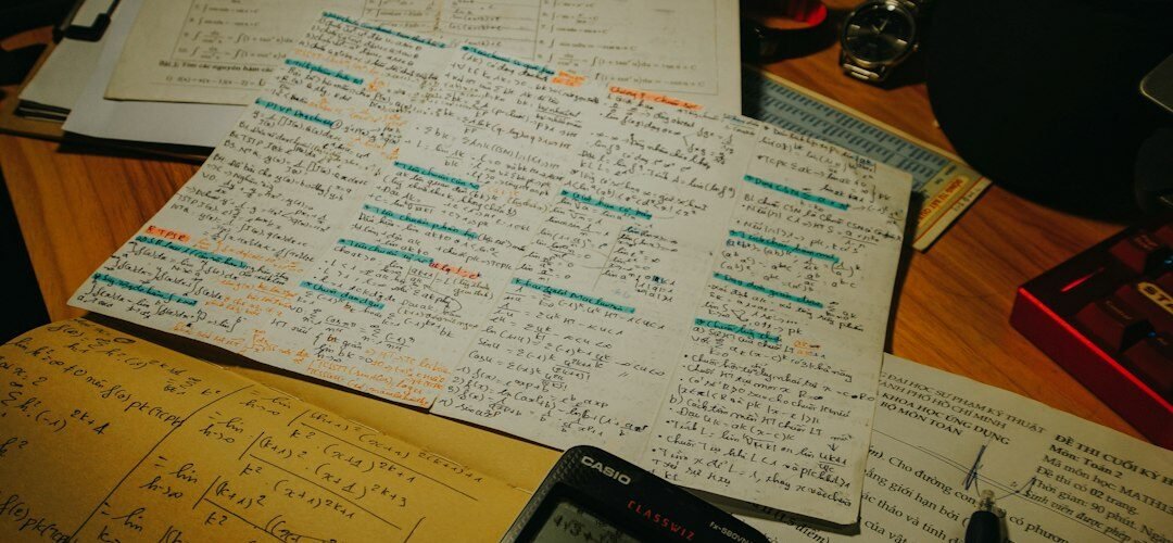 Calculator, study papers, pens and mathematics notes